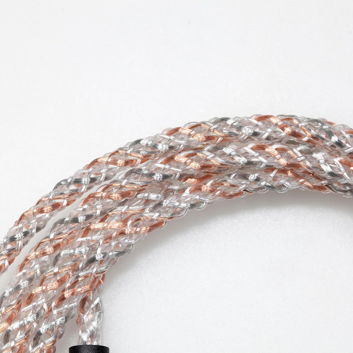 Close-up of braided cable with copper and silver strands on a white background