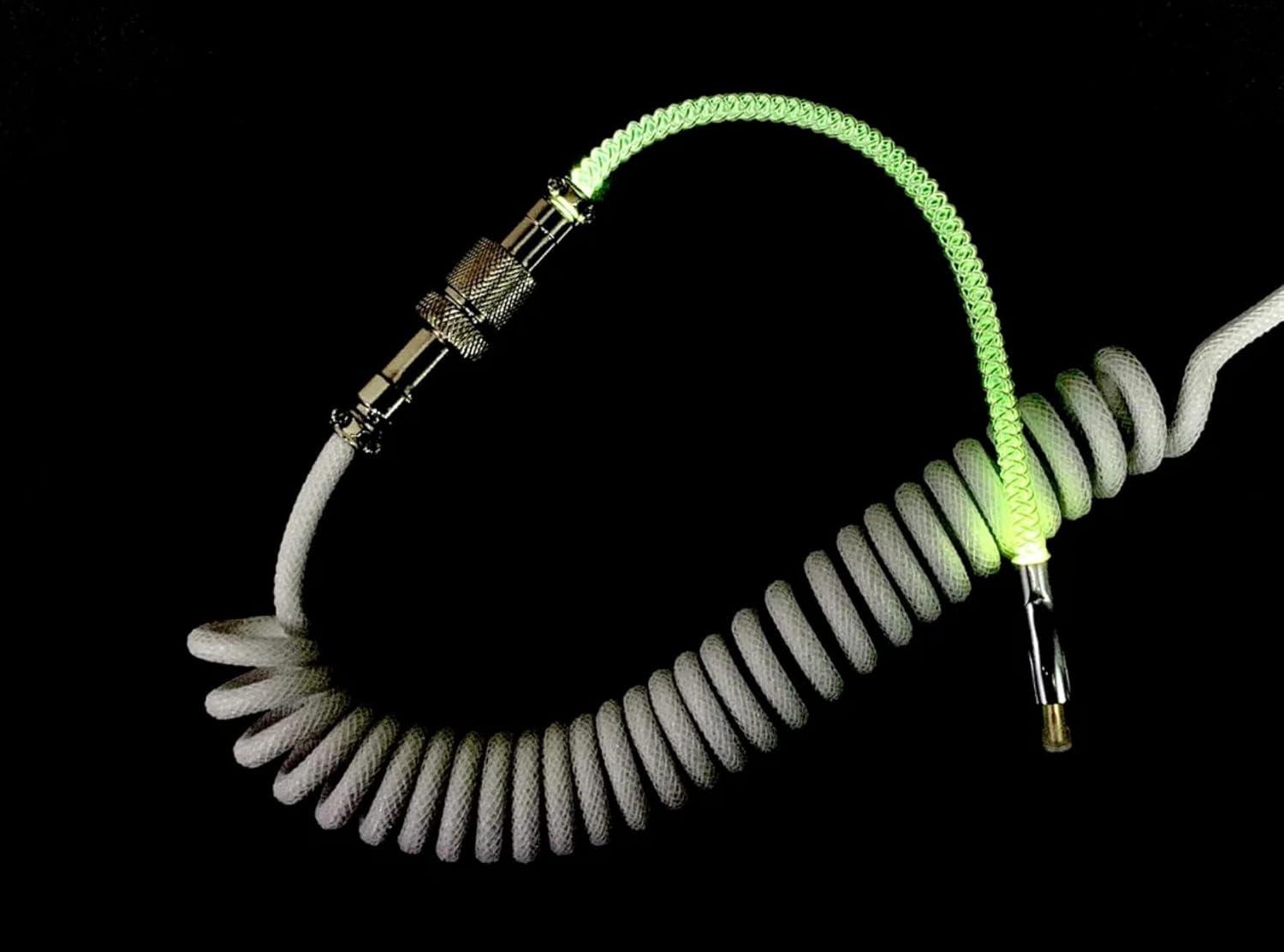 Coiled hose with metallic connectors on a black background