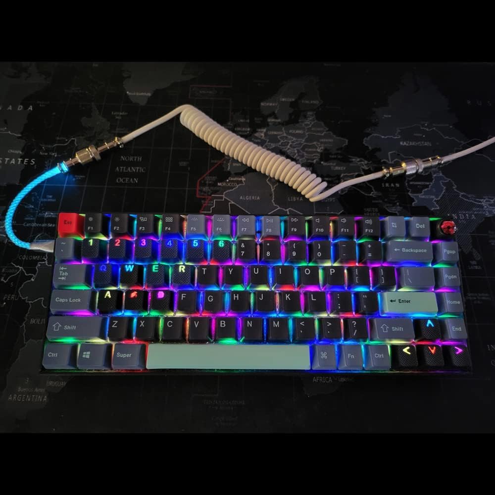 RGB keyboard with coiled cable on a world map background